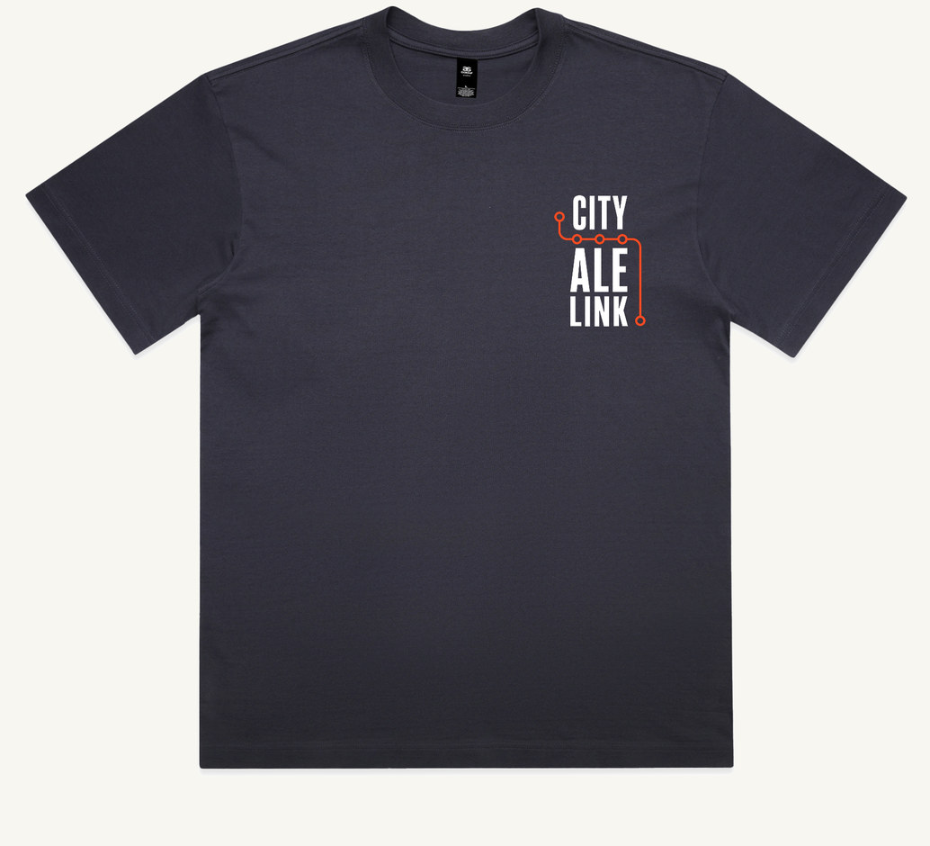The front of the tee: a deep ink blue heavyweight box tee with a small left-chest print, the words CITY ALE LINK stacked in white type with an orange route line turning around them and five circular stops set along it.